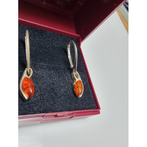 195 - Pair of 925 silver drop earrings inset with genuine amber stones. In clean condition, boxed.