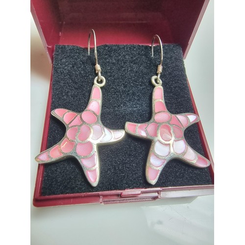 203 - Pair of pretty starfish formed drop earrings inset with pink mother of pearl. In good clean conditio... 