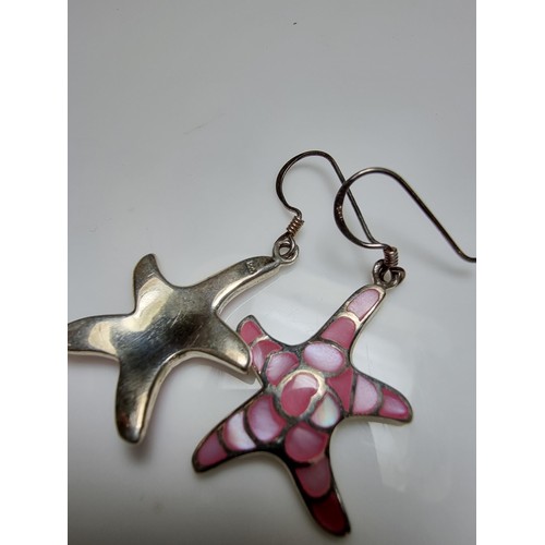 203 - Pair of pretty starfish formed drop earrings inset with pink mother of pearl. In good clean conditio... 