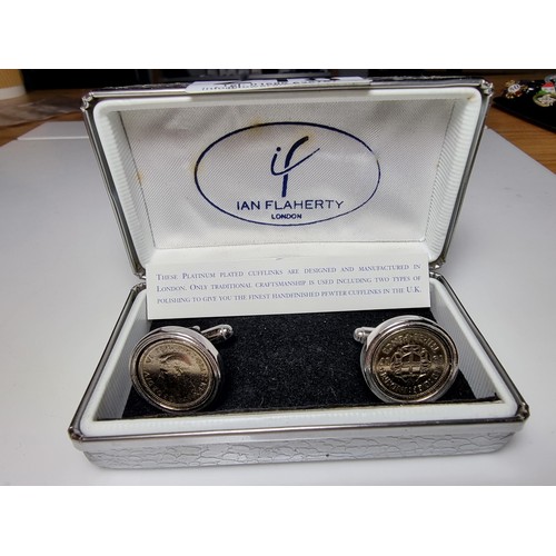 218 - Pair of unused platinum plated pewter cufflinks inset with three pence coins by Ian Flaherty London.