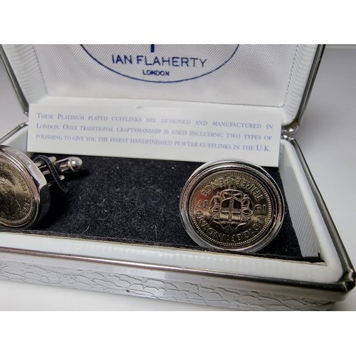 218 - Pair of unused platinum plated pewter cufflinks inset with three pence coins by Ian Flaherty London.