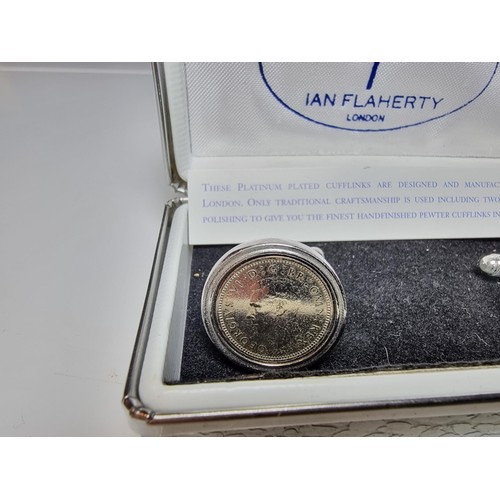 218 - Pair of unused platinum plated pewter cufflinks inset with three pence coins by Ian Flaherty London.