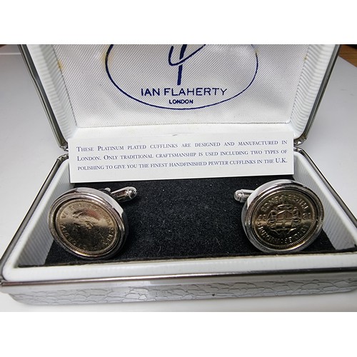 218 - Pair of unused platinum plated pewter cufflinks inset with three pence coins by Ian Flaherty London.