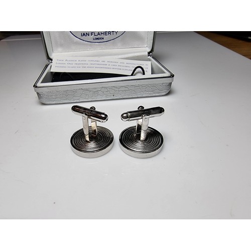 218 - Pair of unused platinum plated pewter cufflinks inset with three pence coins by Ian Flaherty London.