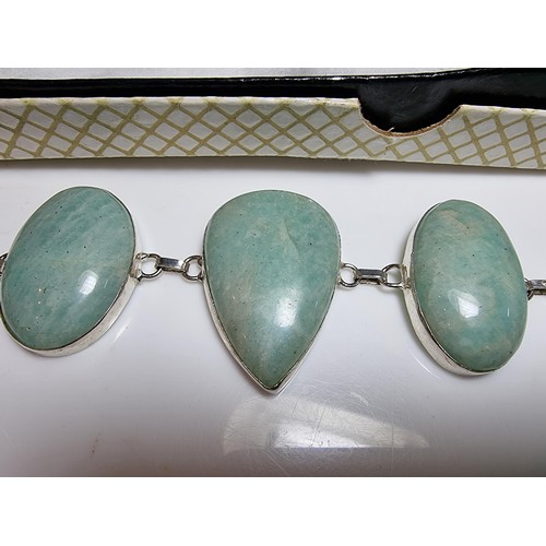 219 - 925 silver bracelet inset with five large polished Amazonite stones in good clean condition. Boxed. ... 