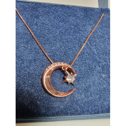 221 - Rose gold plated on solid 925 silver necklace featuring a moon pendant with a dangling star inset wi... 