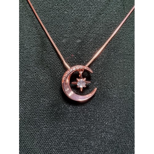 221 - Rose gold plated on solid 925 silver necklace featuring a moon pendant with a dangling star inset wi... 