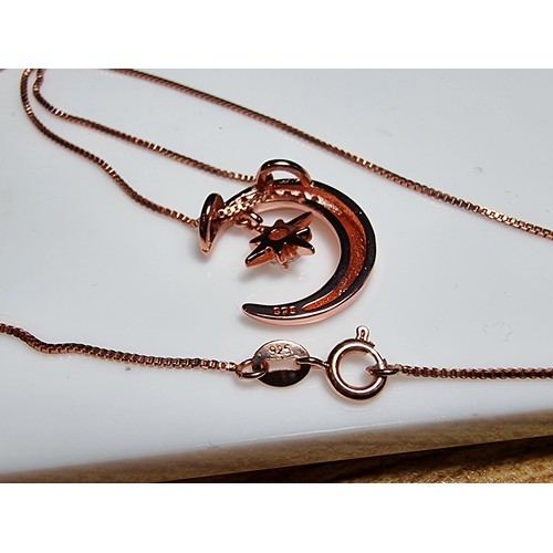 221 - Rose gold plated on solid 925 silver necklace featuring a moon pendant with a dangling star inset wi... 