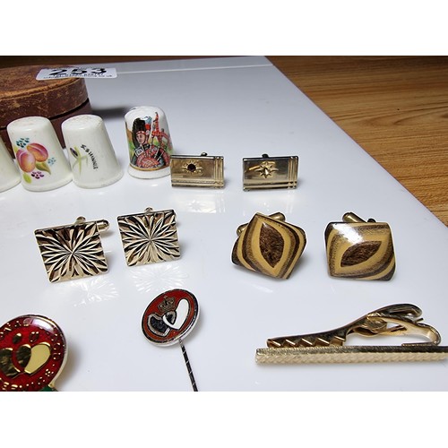 253 - Small qty of collectables to include 8x Royal Worcester thimbles, 4x pairs of cufflinks, pin badges,... 