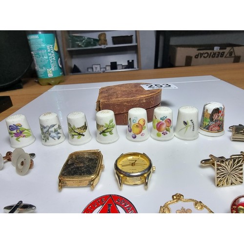 253 - Small qty of collectables to include 8x Royal Worcester thimbles, 4x pairs of cufflinks, pin badges,... 