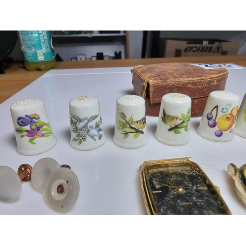 253 - Small qty of collectables to include 8x Royal Worcester thimbles, 4x pairs of cufflinks, pin badges,... 