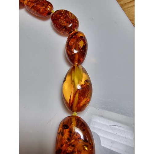 259 - Large vintage chunky natural Baltic amber beaded necklace with inclusions, hand knotted, presenting ... 