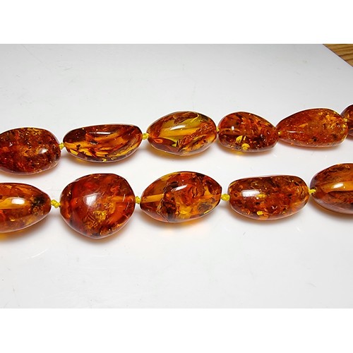 259 - Large vintage chunky natural Baltic amber beaded necklace with inclusions, hand knotted, presenting ... 