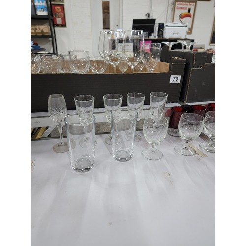 70 - 2x boxes containing a large quantity of drinking glasses inc cranberry glass sherry glasses, pint gl... 