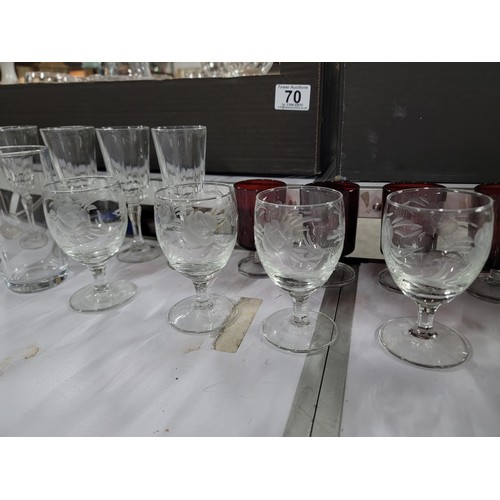 70 - 2x boxes containing a large quantity of drinking glasses inc cranberry glass sherry glasses, pint gl... 