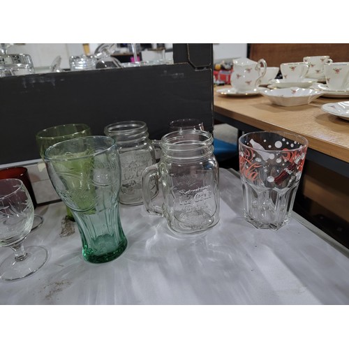 70 - 2x boxes containing a large quantity of drinking glasses inc cranberry glass sherry glasses, pint gl... 