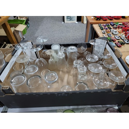 70 - 2x boxes containing a large quantity of drinking glasses inc cranberry glass sherry glasses, pint gl... 