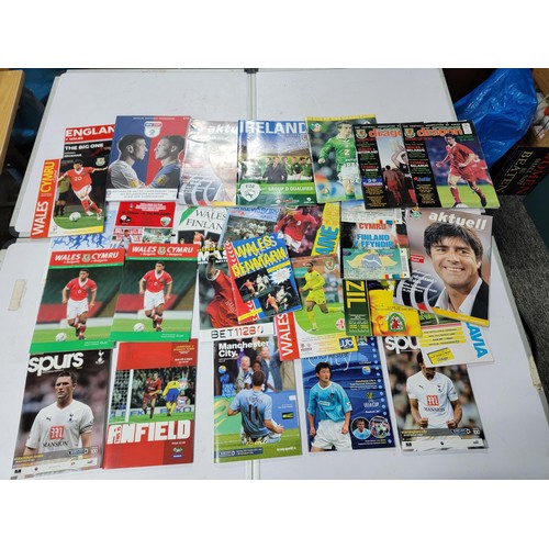 95 - A large quantity of football programmes for different clubs and internationals inc one signed by cov... 