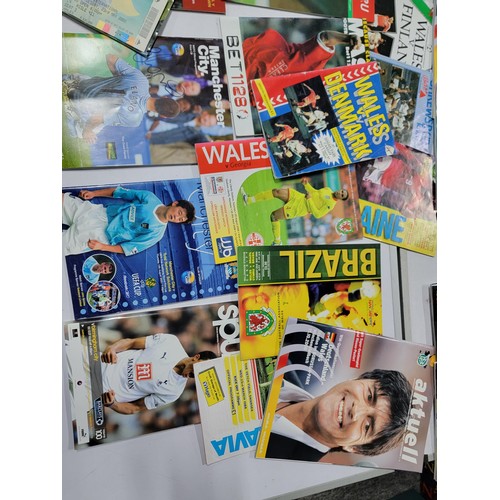 95 - A large quantity of football programmes for different clubs and internationals inc one signed by cov... 