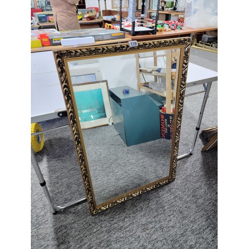 110 - Large gilt framed bevel edged mirror in good order with scrolling to the frame measures 95cm high by... 