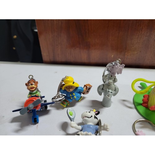 137 - Collection 7x keyrings inc Paddington Bear, Judge Dread, Mr Blobby, Disney figure of a bear in a pla... 