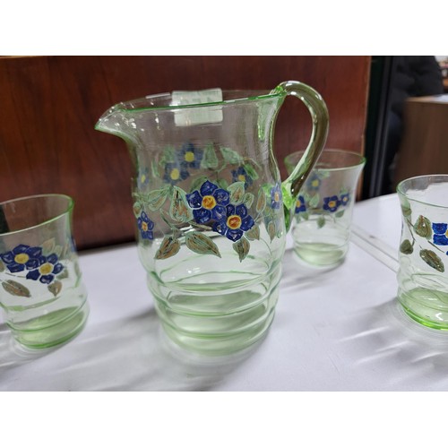 153 - Green glass hand painted lemonade set inc a large jug and 5 glasses, one glass has a small nibble to... 