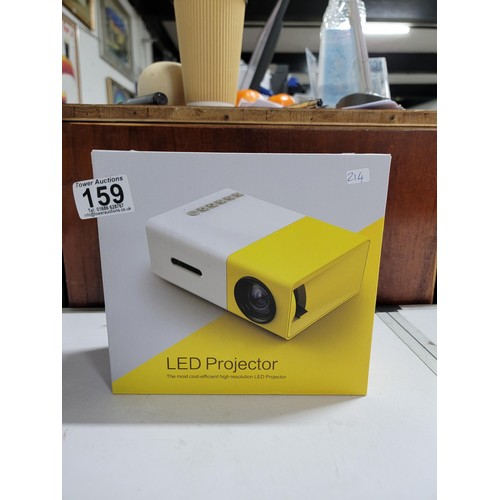 159 - A boxed Atrii LED projector complete with power cable accessories and instructions