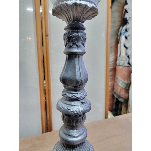 393 - Large resin pillar candle stand complete with glass pot and pillar candle, painted in grey with scro... 