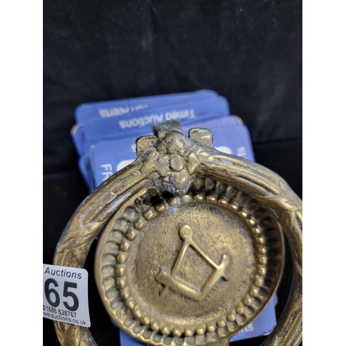 165 - Good quality brass door knocker with a masonic logo to the centre in good order measures 16cm high d... 