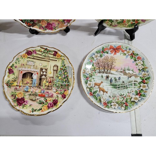 323 - Quantity of Royal Albert bone china Christmas plates with gilt edging covering consecutive years fro... 