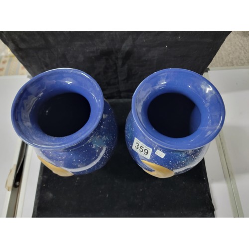 359 - Pair of blue glaze vases both with the a symbol of the moon and the sun respectively , one has nibbl... 