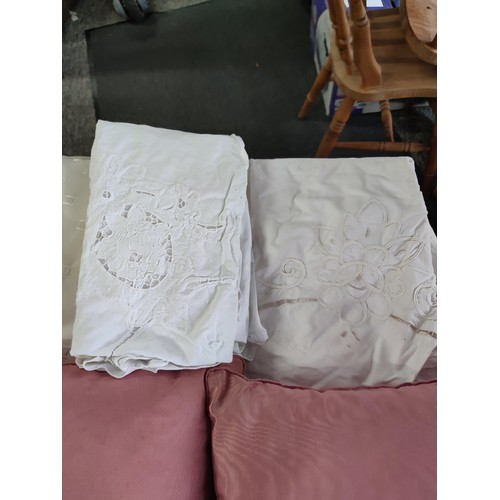 474 - A large box of assorted linen inc cushions, pair of cream curtains, table clothes inc a crocheted ta... 