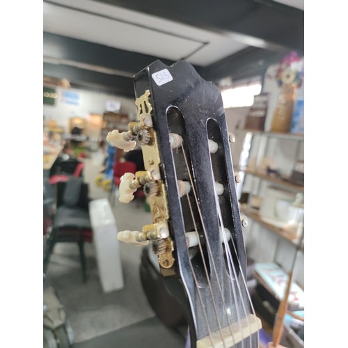 475 - An Ashton electric acoustic nylon strung guitar complete with stand. All in working order, includes ... 