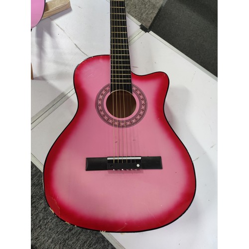 477 - 2x pink acoustic guitars inc an elevation guitar and one other, along with a good quality guitar sta... 