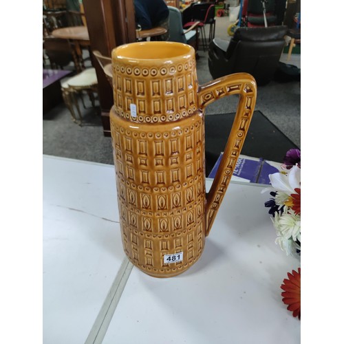 481 - Large West German ceramic jug with plastic flower decoration, in good order stands at 44cm high