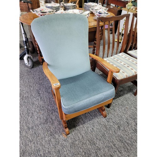 497 - Good quality rocking arm chair in blue dralon, with wooden arm rests, measures 84cm high, 56cm wide ... 