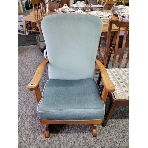 497 - Good quality rocking arm chair in blue dralon, with wooden arm rests, measures 84cm high, 56cm wide ... 