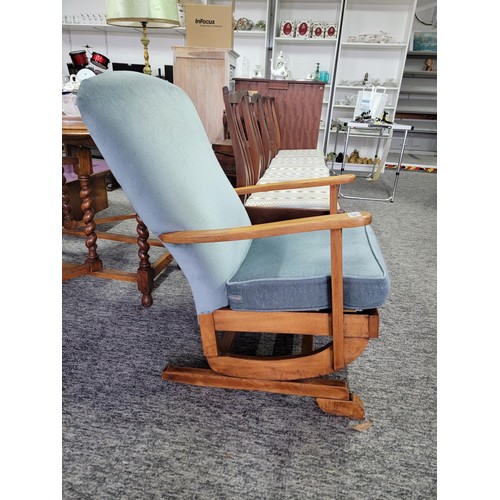 497 - Good quality rocking arm chair in blue dralon, with wooden arm rests, measures 84cm high, 56cm wide ... 