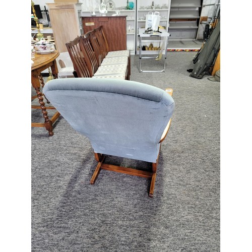 497 - Good quality rocking arm chair in blue dralon, with wooden arm rests, measures 84cm high, 56cm wide ... 