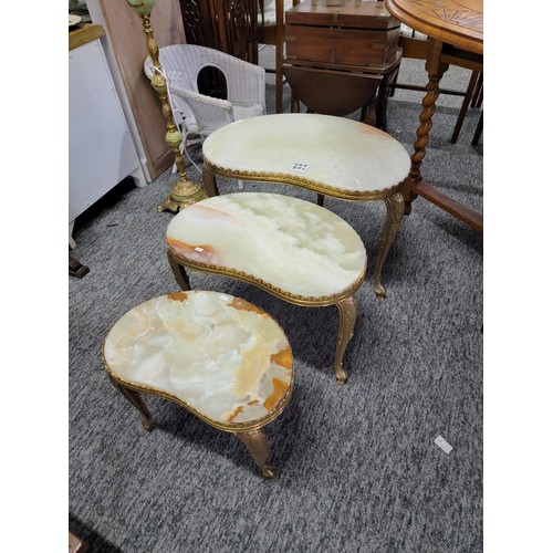 501 - Nest of three Onyx tables with brass frames/legs giving a light green appearance  in good order larg... 