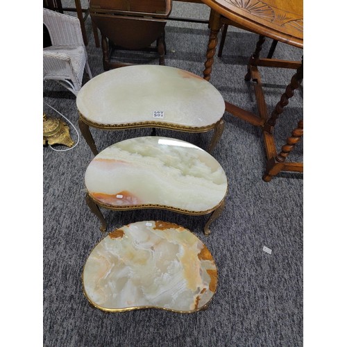 501 - Nest of three Onyx tables with brass frames/legs giving a light green appearance  in good order larg... 