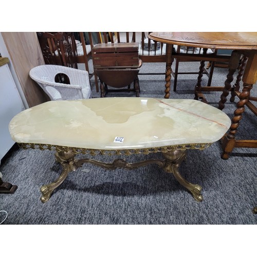 502 - Onyx oval coffee table on brass frame giving super design and in good solid order 
Its 104cm by 45cm