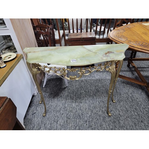 504 - Onyx half moon hall table on light green with brass frame/legs in good order, measuring 74cm high, 9... 