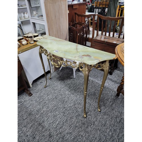 504 - Onyx half moon hall table on light green with brass frame/legs in good order, measuring 74cm high, 9... 