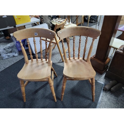 515 - A pair of beech farmhouse kitchen/dining chairs standing at 84cm high, 37cm wide and 39cm deep