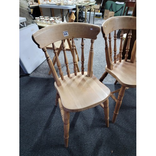 515 - A pair of beech farmhouse kitchen/dining chairs standing at 84cm high, 37cm wide and 39cm deep