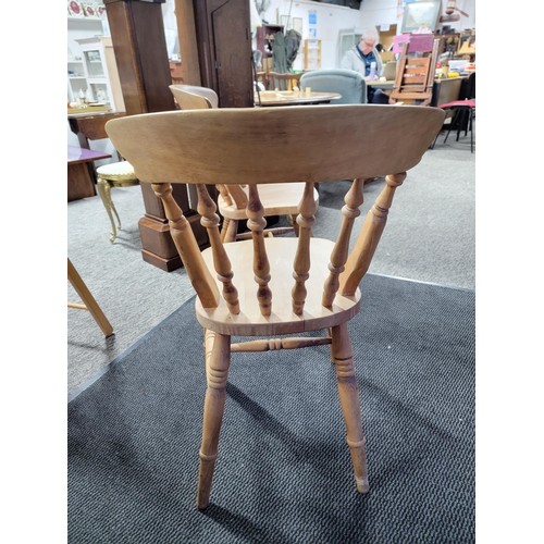 515 - A pair of beech farmhouse kitchen/dining chairs standing at 84cm high, 37cm wide and 39cm deep