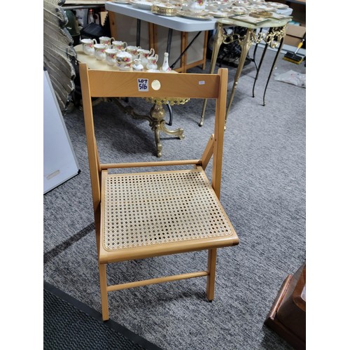 516 - Rattan and wood folding chair ideal for picnics etc measures 79cm high, 38cm wide and 39cm deep