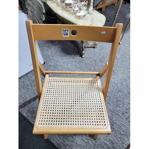 516 - Rattan and wood folding chair ideal for picnics etc measures 79cm high, 38cm wide and 39cm deep