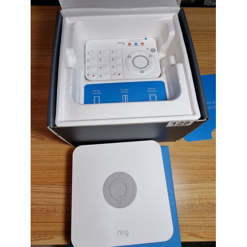 128 - An as new boxed ring alarm base station 5 piece starter kit, first generation. To include base stati... 